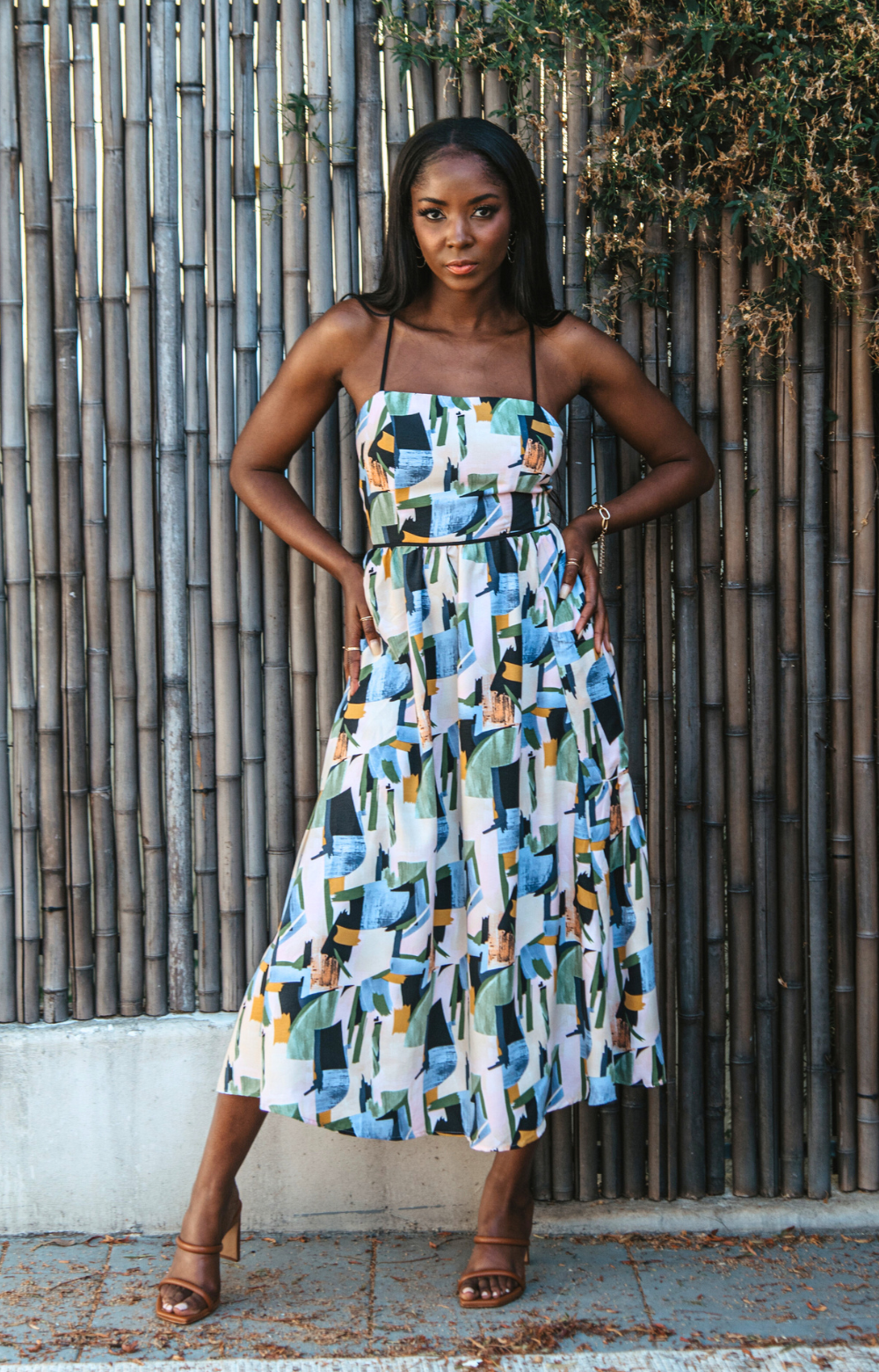 Introducing our vibrant Jasmine Strappy Back Midi Dress with a colorful pattern. This midi dress features adjustable tassel straps and a light, breezy fabric – perfect for easy style on spring and summer days. Elevate your look by pairing it with heels for a chic dinner night out. Embrace the versatility of this dress for any occasion.