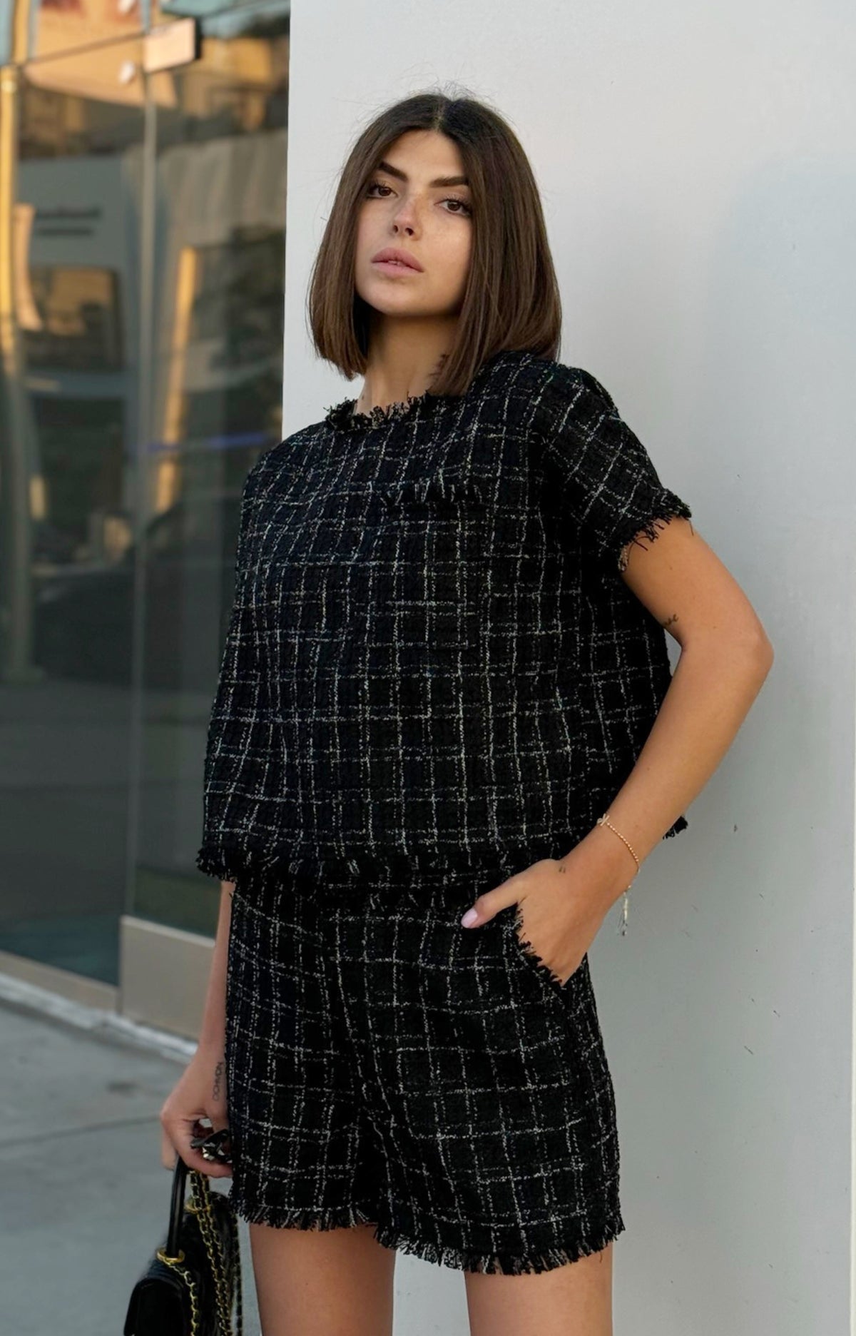 Step into fall fashion with our Milano Tweed Frayed Hem Shorts. These chic shorts feature beautiful plaid details and a trendy frayed hem, perfect for stylish layering. Complete your look by pairing them with the Milano Tweed Frayed Hem Top for a coordinated outfit that exudes effortless elegance.&nbsp;
