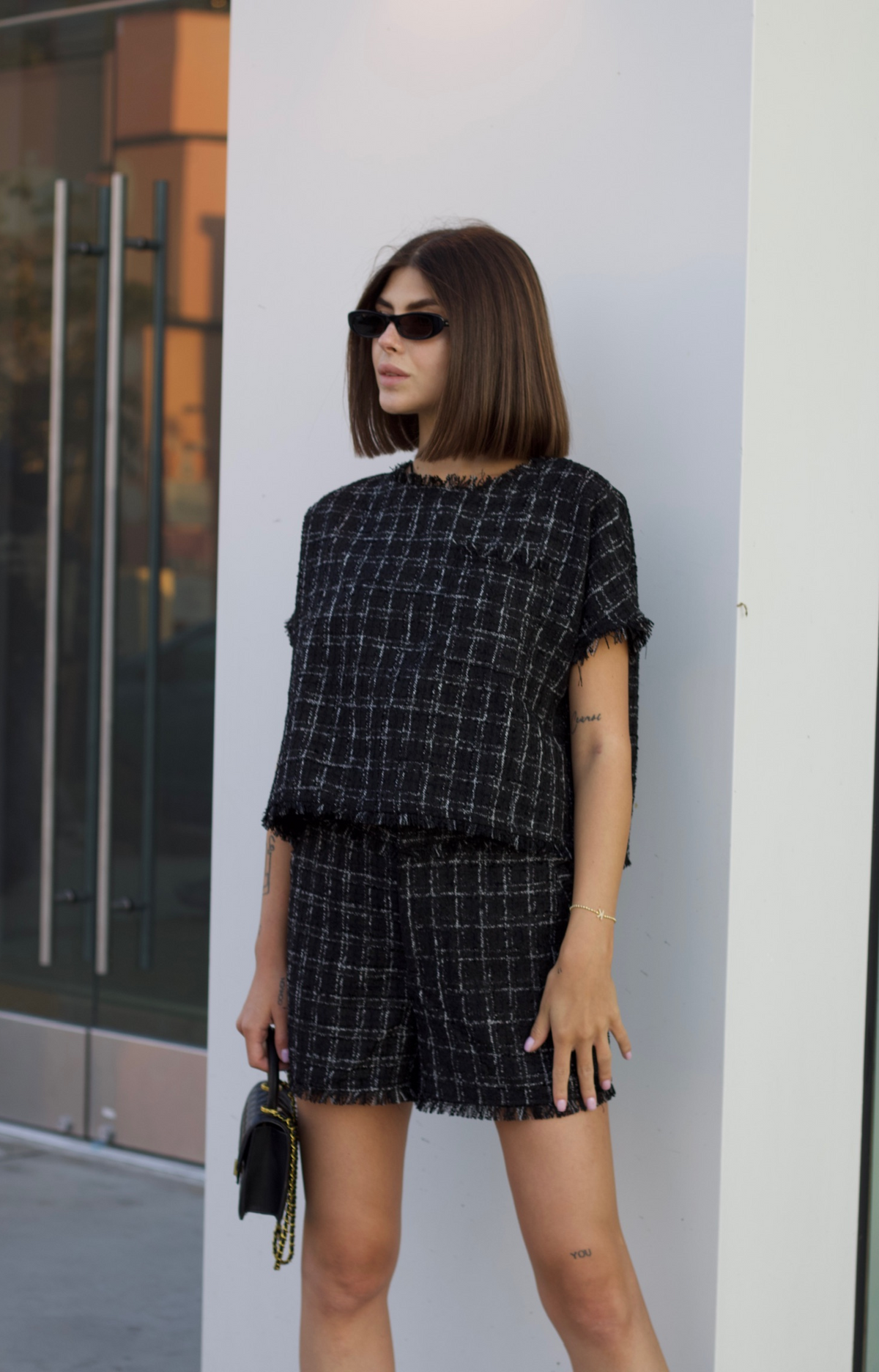 Step into fall fashion with our Milano Tweed Frayed Hem Shorts. These chic shorts feature beautiful plaid details and a trendy frayed hem, perfect for stylish layering. Complete your look by pairing them with the Milano Tweed Frayed Hem Top for a coordinated outfit that exudes effortless elegance.&nbsp;