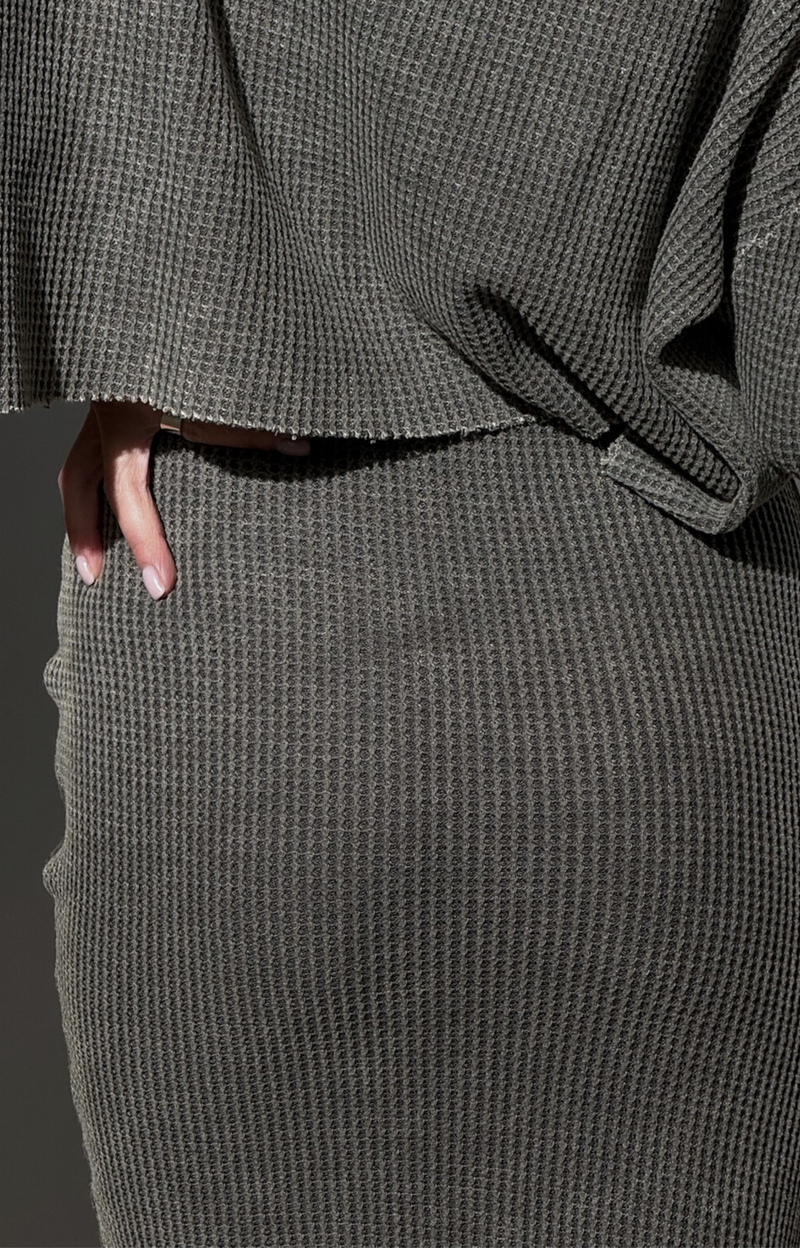 Explore the Tina Rib Midi Knit Skirt, featuring a drawstring waist for a perfect fit. With its stretchy fabric and comfortable design, this stylish rib skirt pairs beautifully with the Tina Rib Long Sleeve Knit Top for a chic, coordinated look!