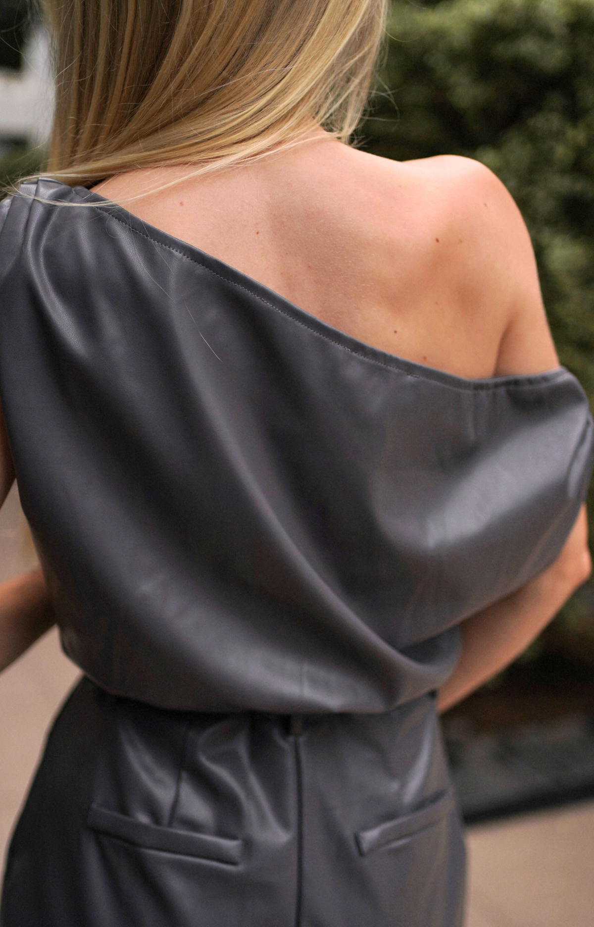 Elevate your look with the Gina Faux Leather Top. This chic top features a stylish draped shoulder design and an elastic hem for a comfortable fit. Crafted from high-quality faux leather, this faux leather top perfect for any occasion. Pair it with the Gina Faux Leather Shorts for a complete, fashionable ensemble that exudes confidence and flair.