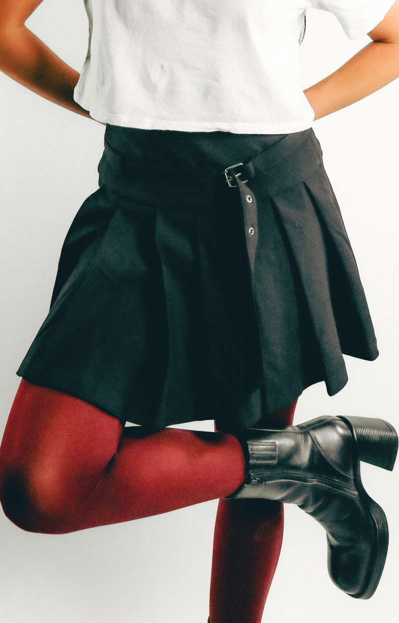 Elevate your wardrobe with the Jen Pleated Mini Skirt, where chic style meets modern design. This tailored skirt features flattering pleats and a self belt that adds a touch of sophistication to your look. Designed with a convenient side zipper, the Jen Mini Skirt combines functionality with a trendy silhouette. Effortlessly stylish, it’s perfect for creating fashionable outfits that stand out. Step out in confidence with this must-have mini skirt that embodies a hip, contemporary vibe.