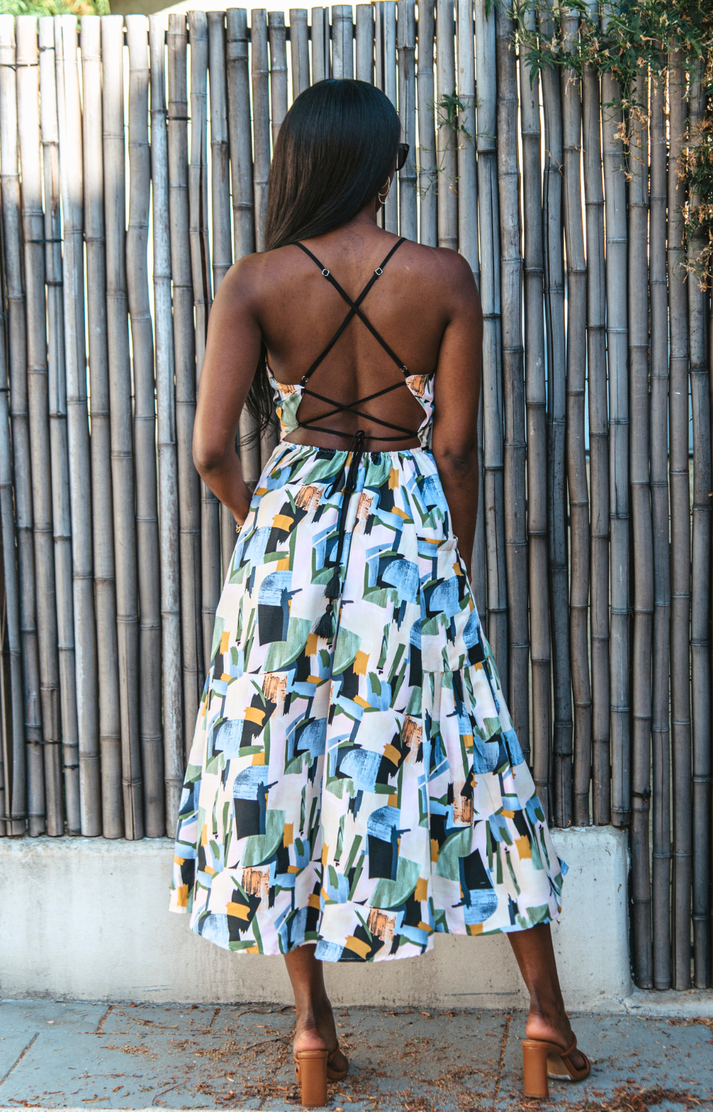 Introducing our vibrant Jasmine Strappy Back Midi Dress with a colorful pattern. This midi dress features adjustable tassel straps and a light, breezy fabric – perfect for easy style on spring and summer days. Elevate your look by pairing it with heels for a chic dinner night out. Embrace the versatility of this dress for any occasion.