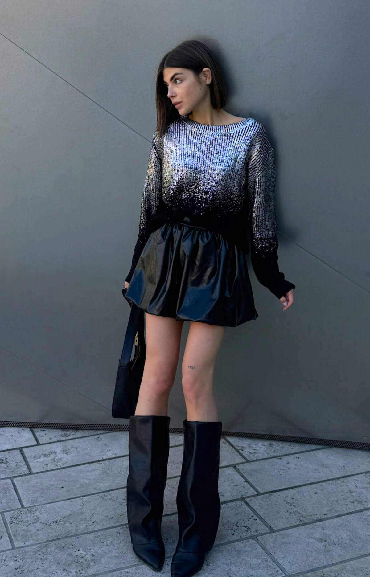 Discover the Ariel Faux Leather Bubble Mini Skirt, featuring a super cute design, elastic waistband, and comfortable fit. Elevate your wardrobe with this edgy and chic skirt that's perfect for any occasion!