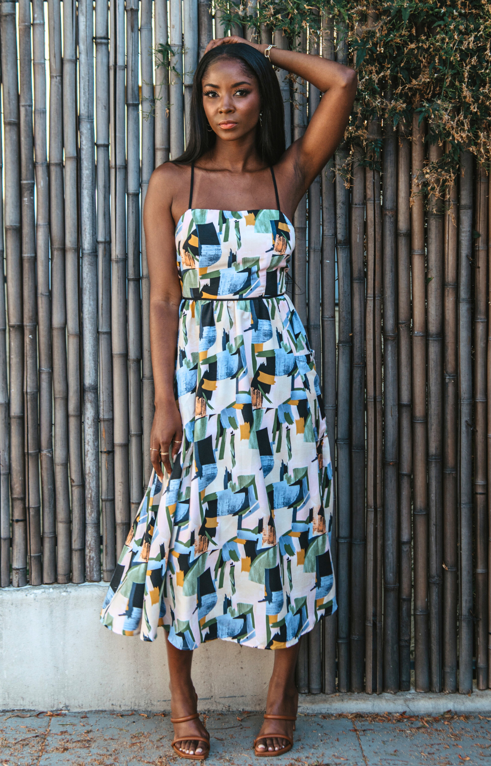 Introducing our vibrant Jasmine Strappy Back Midi Dress with a colorful pattern. This midi dress features adjustable tassel straps and a light, breezy fabric – perfect for easy style on spring and summer days. Elevate your look by pairing it with heels for a chic dinner night out. Embrace the versatility of this dress for any occasion.
