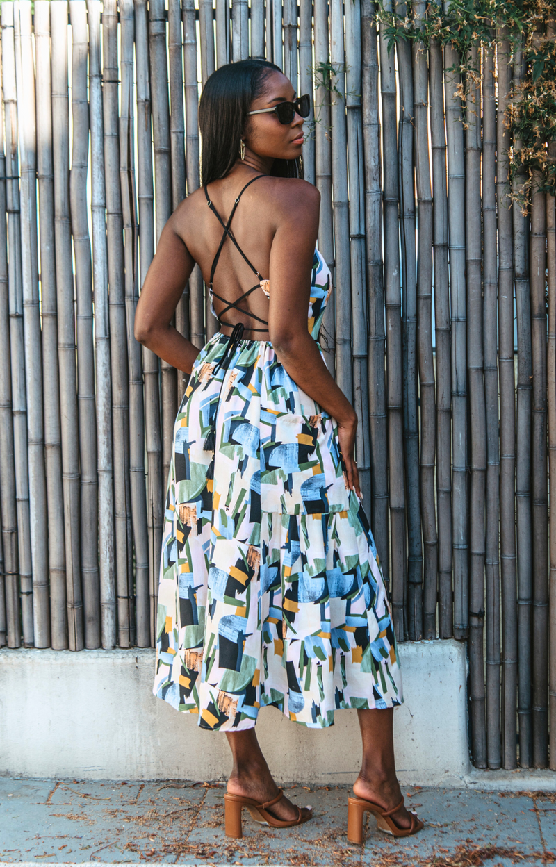 Introducing our vibrant Jasmine Strappy Back Midi Dress with a colorful pattern. This midi dress features adjustable tassel straps and a light, breezy fabric – perfect for easy style on spring and summer days. Elevate your look by pairing it with heels for a chic dinner night out. Embrace the versatility of this dress for any occasion.