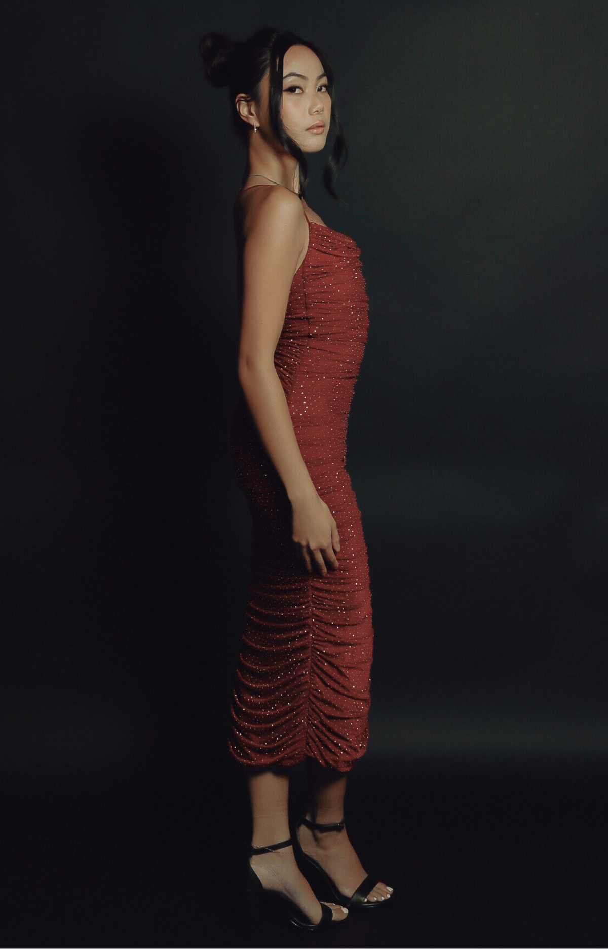 Turn heads in the Kelly Crystal Ruched Midi Dress, a show-stopping piece with sparkling crystal details and a stunning criss-cross back strap design. The flattering ruched silhouette, combined with soft, stretchy fabric, creates an elegant and glamorous look perfect for special occasions. Dazzle with every step in this gorgeous midi dress.