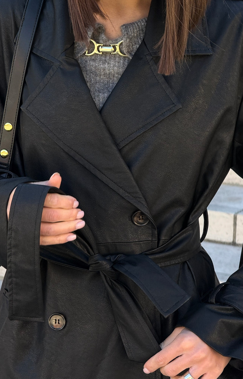 Step out in style with our Kylie Faux Leather Trench Coat, expertly crafted from high-quality faux leather that mimics the rich texture and sheen of genuine leather. This chic coat not only adds a touch of sophistication to any outfit but also provides a cruelty-free alternative that you can feel good about wearing.&nbsp;Featuring premium faux leather fabric, deep pockets, and a fashionable belt.
