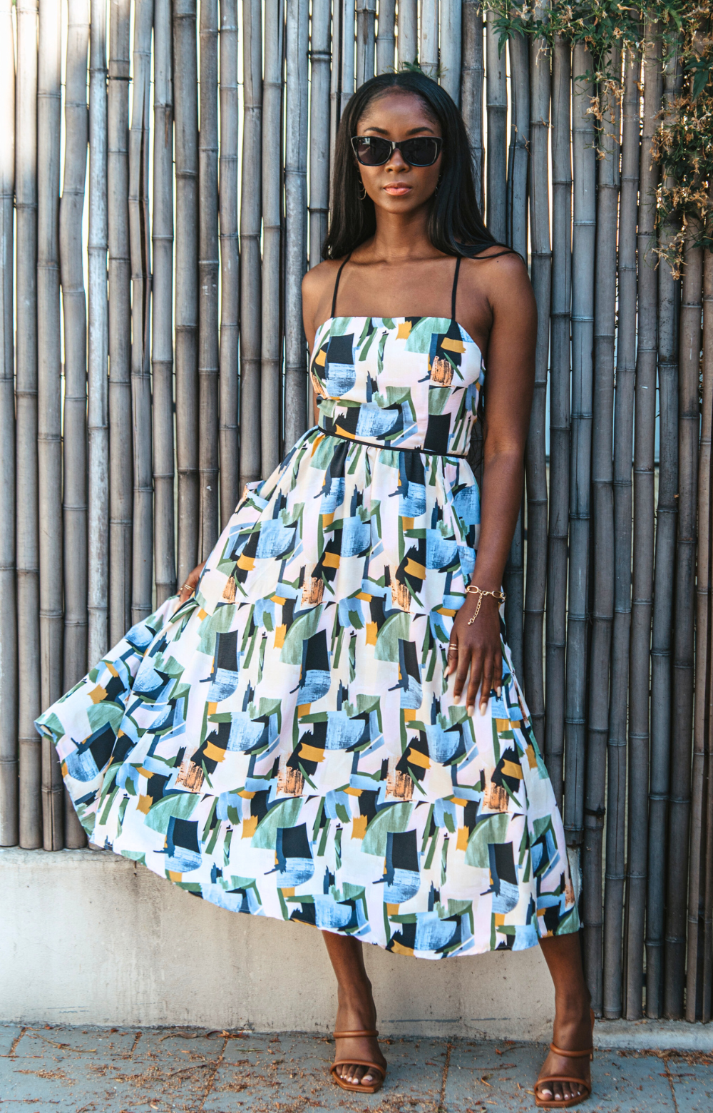 Introducing our vibrant Jasmine Strappy Back Midi Dress with a colorful pattern. This midi dress features adjustable tassel straps and a light, breezy fabric – perfect for easy style on spring and summer days. Elevate your look by pairing it with heels for a chic dinner night out. Embrace the versatility of this dress for any occasion.