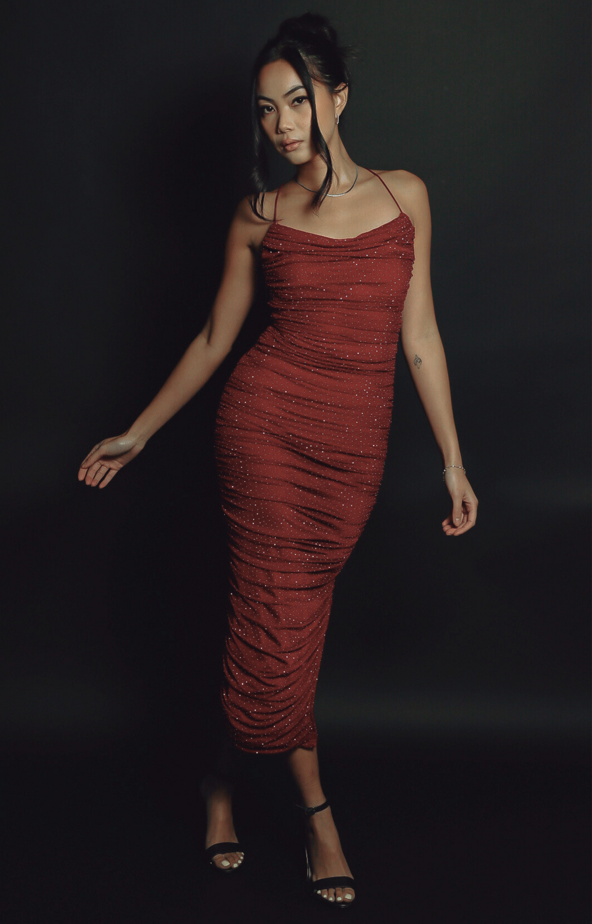 Turn heads in the Kelly Crystal Ruched Midi Dress, a show-stopping piece with sparkling crystal details and a stunning criss-cross back strap design. The flattering ruched silhouette, combined with soft, stretchy fabric, creates an elegant and glamorous look perfect for special occasions. Dazzle with every step in this gorgeous midi dress.