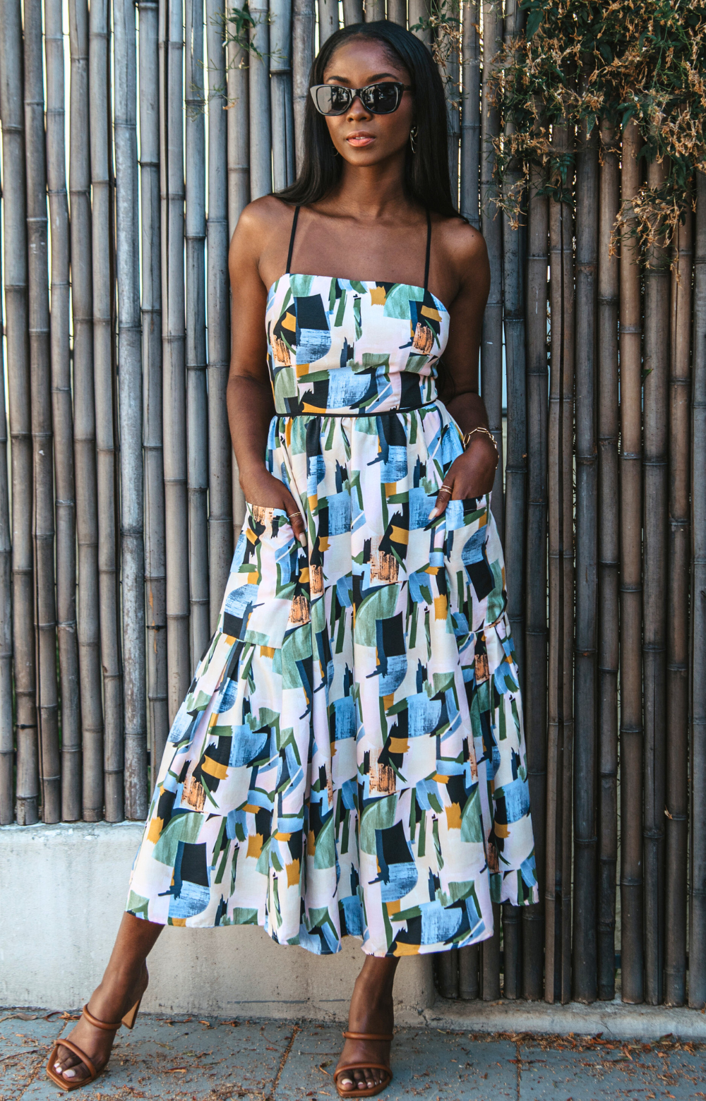 Introducing our vibrant Jasmine Strappy Back Midi Dress with a colorful pattern. This midi dress features adjustable tassel straps and a light, breezy fabric – perfect for easy style on spring and summer days. Elevate your look by pairing it with heels for a chic dinner night out. Embrace the versatility of this dress for any occasion.
