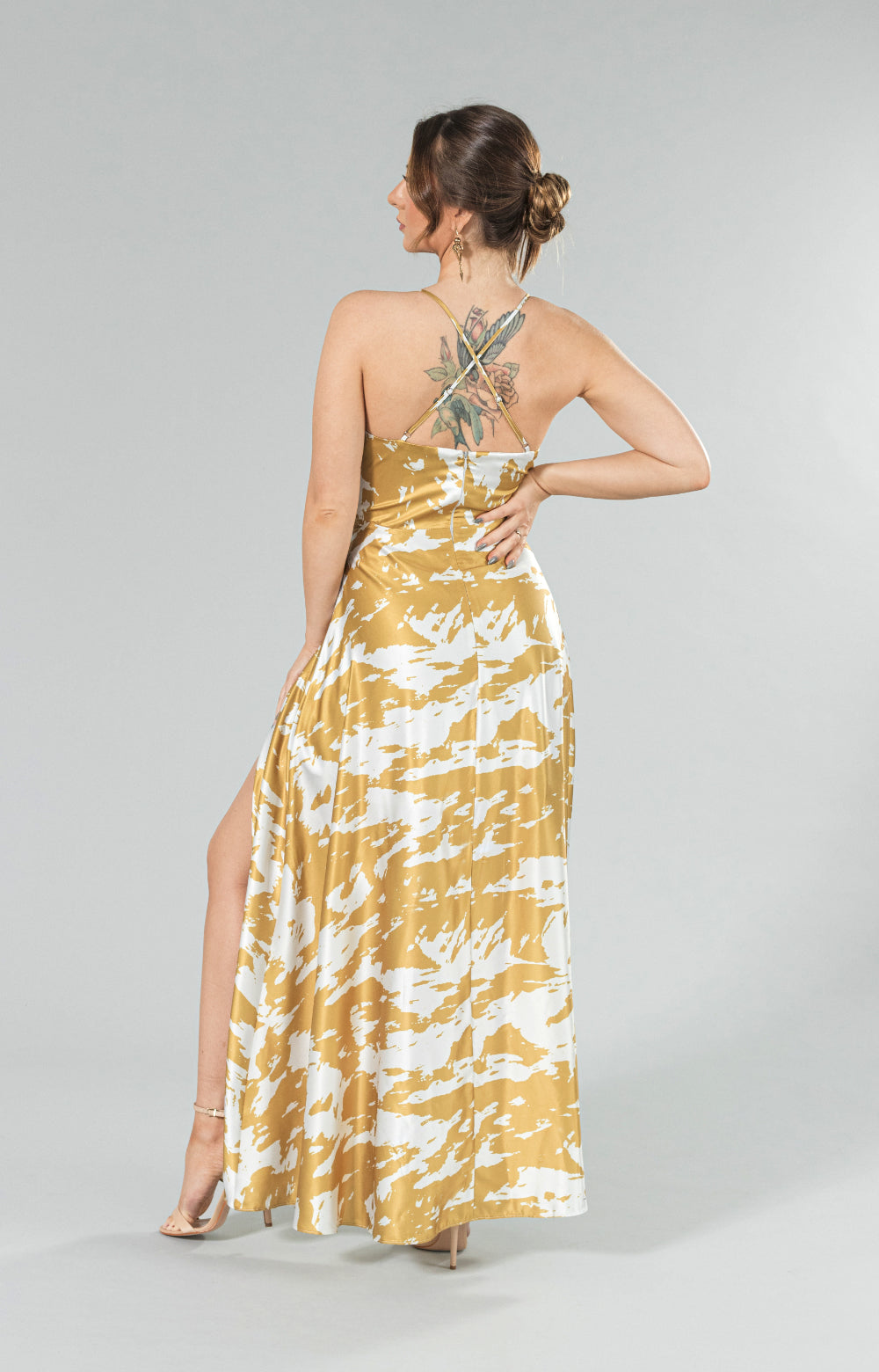 Discover pure elegance and luxury in our Sofia long dress with slit, adorned in a mesmerizing yellow and white pattern. With a flirty front leg slit, alluring strap details and invisible zipper at center back this dress is truly a vision of romantic femininity. Expertly crafted with the finest quality fabric, it exudes an air of extravagance, fitting for any special occasion. Experience the feeling of graceful delicacy and radiate timeless beauty in this enchanting maxi dress.