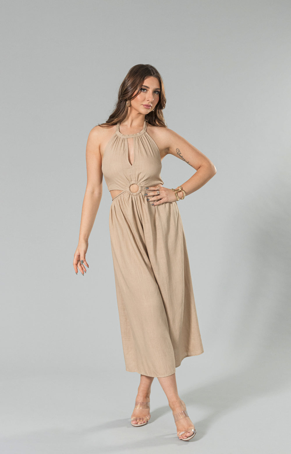 Get ready to turn heads in our stylish Sahara linen wide leg jumpsuit. Made from lightweight and breathable linen blend fabric, this halter neck jumpsuit features a wide leg capri design, back smocking for a comfortable fit, and a waist tie to enhance your figure. The halter cut out detail adds a playful touch, making it the perfect choice for any occasion. 

