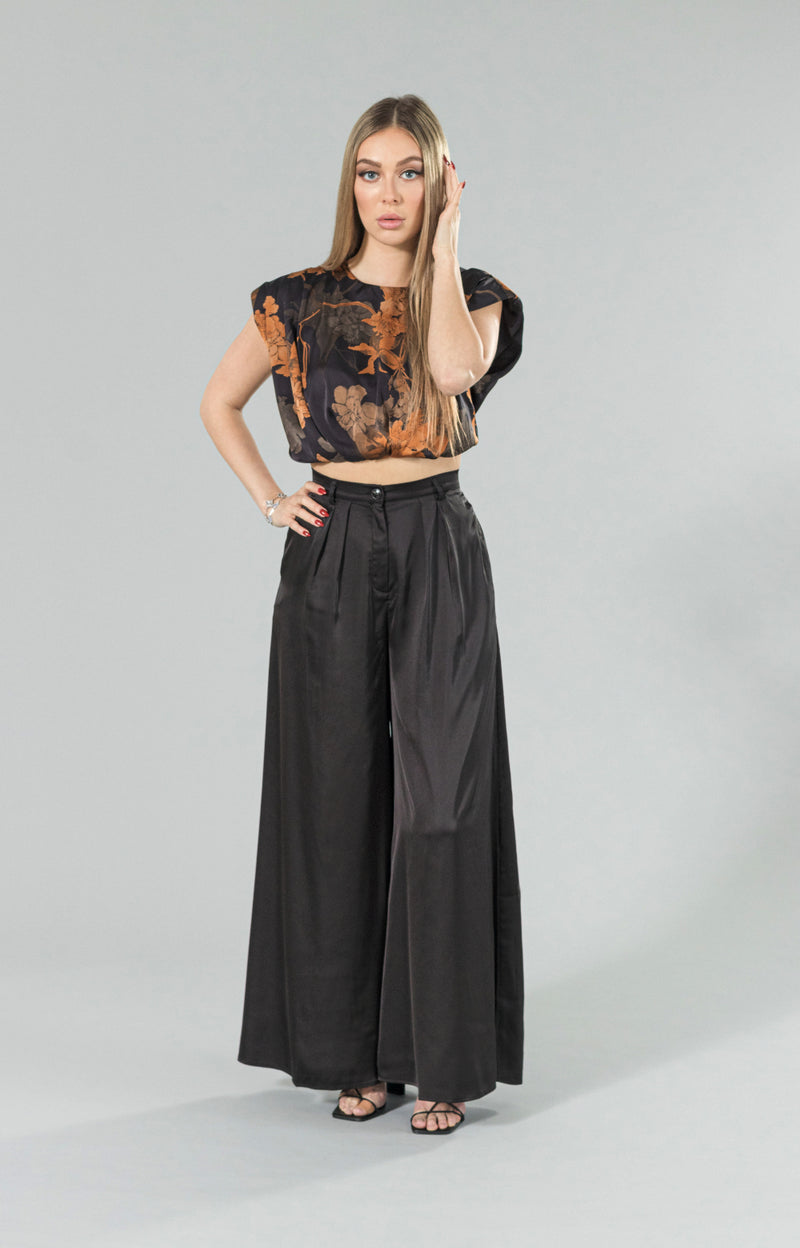 Introducing our shoulder padded Marlina crop top, the perfect addition to your wardrobe for a touch of romance and sophistication. Made with soft satin fabric, this top offers the ultimate comfort while still showcasing a great fit. The padded shoulders add a touch of elegance, creating a beautifully structured silhouette. Perfect for a night out or a special occasion, this satin crop top will elevate any outfit.