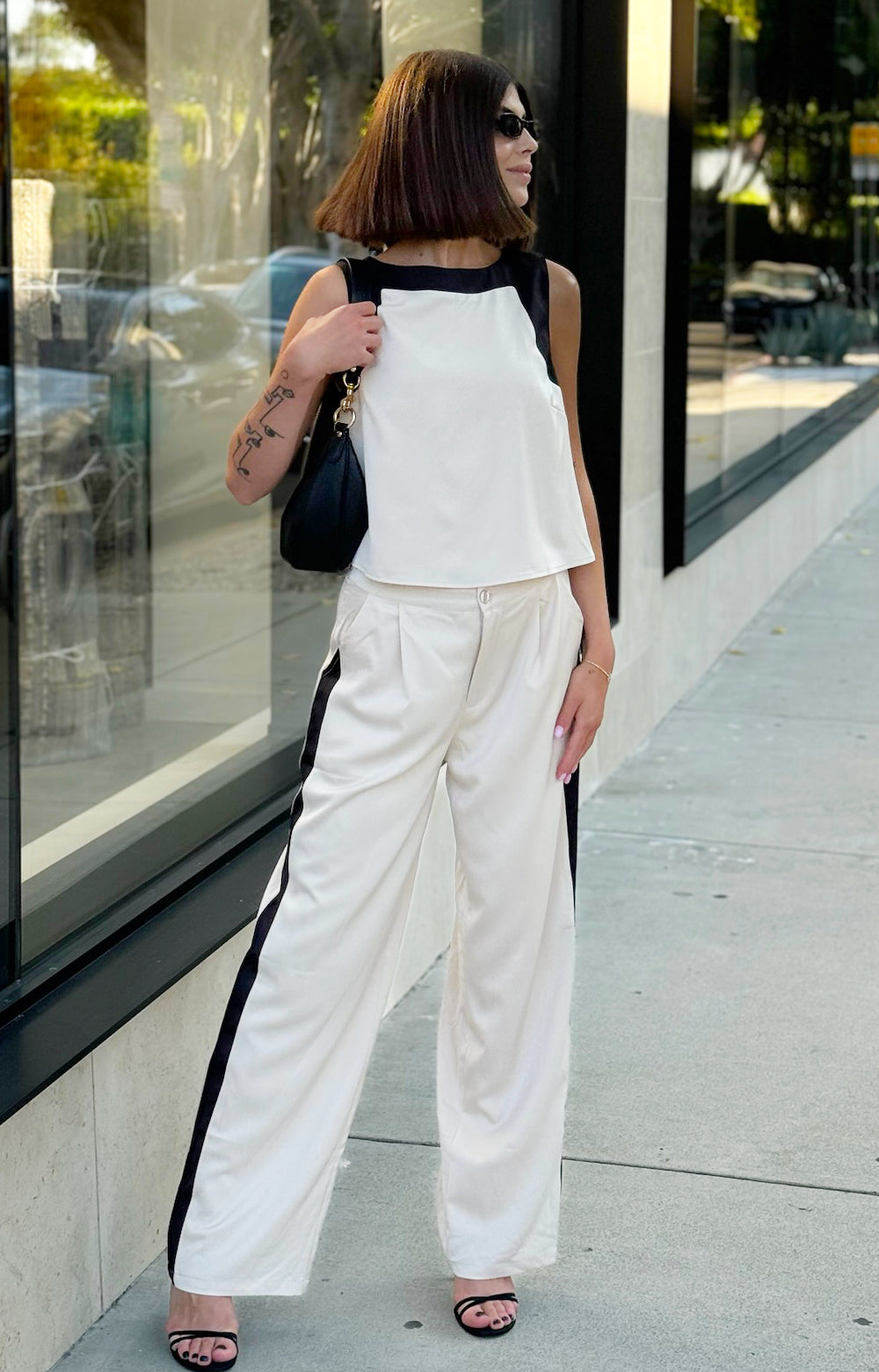 Elevate your wardrobe with our Tiera Tailored long satin feel pants, designed for both style and comfort. Featuring a straight leg cut for a flattering silhouette, this tailored pant includes practical pockets and stylish front pleats that enhance the fit. Crafted from luxurious fabric with eye-catching color block detail, they are perfect for any occasion, from casual outings to sophisticated events. Discover the perfect blend of elegance and functionality with our stunning Tiera Tailored Pant.